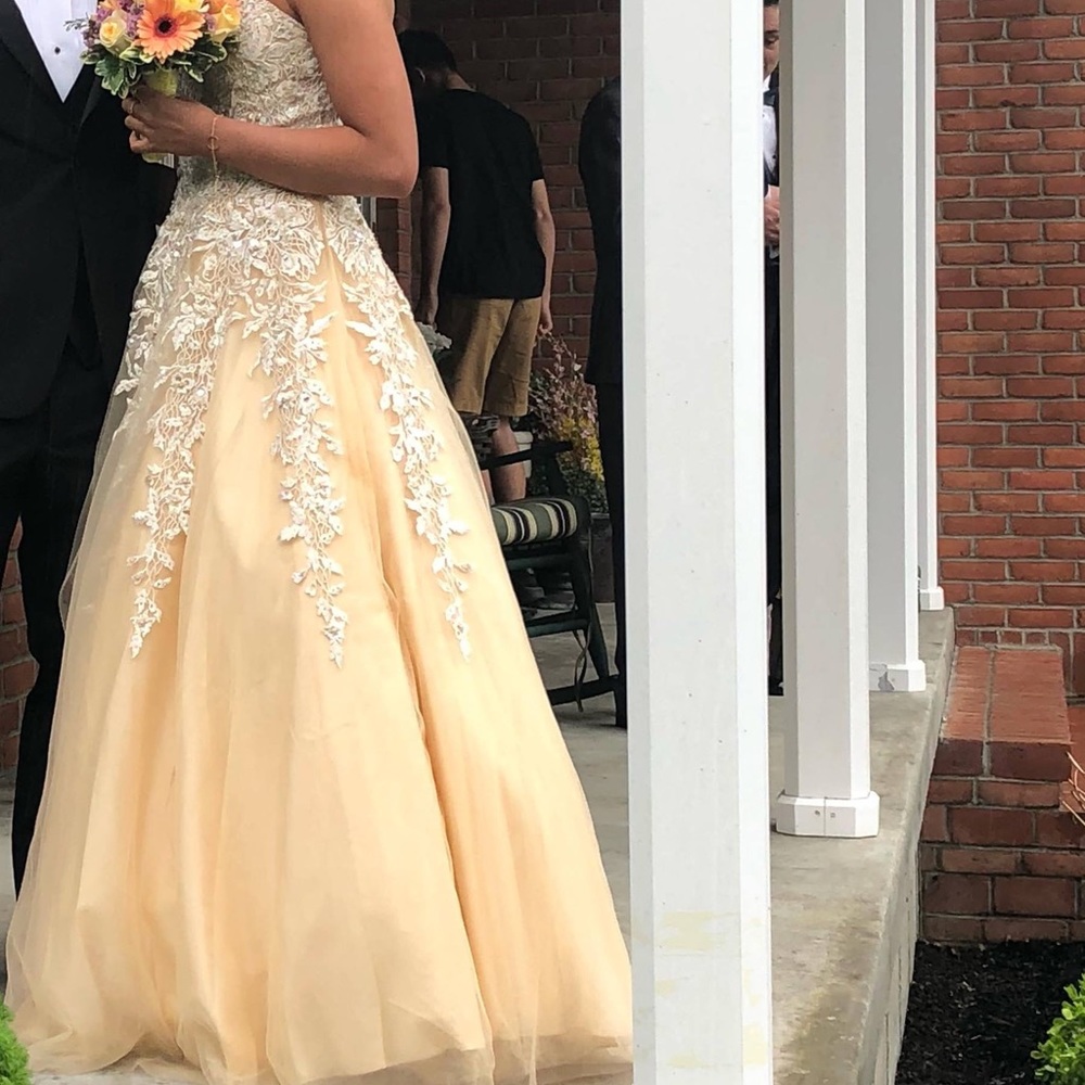 Strapless yellow  pale yellow detailed ball gown .